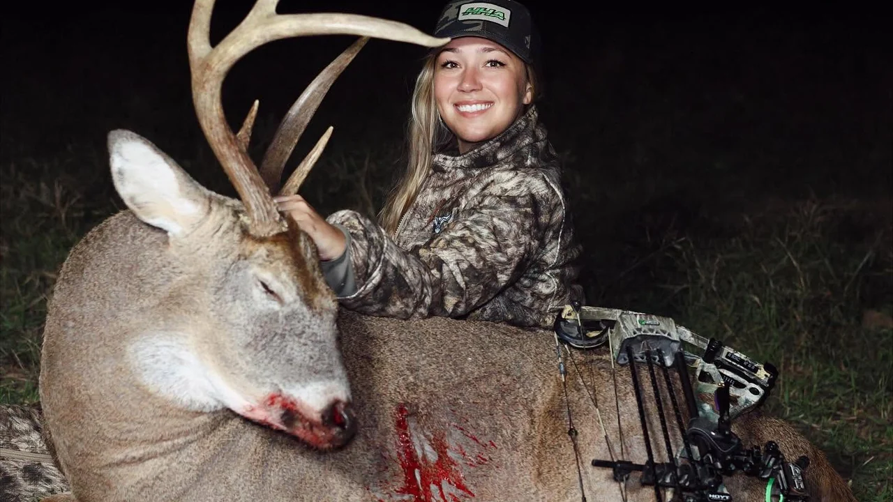 Photo · Casey and her Hoyt with a mature buck